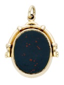 An agate swivel fob, 1924, set with oval-shaped bloodstone and chalcedony panels, mounted in 9ct gold, Birmingham...