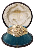 A mid 19th century bloomed gold locket bangle,  the circular compartment decorated with ropetwist wire detail and...