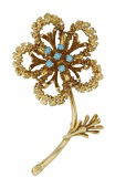 An 18ct gold floral brooch, the textured flowerhead set with turquoise cabochons to the centre, maker’s mark...