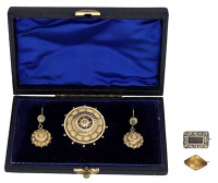 A late 19th century brooch and earring suite, the gold suite of tiered target design, together with two small early...