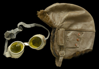 Early Flying or Motoring Helmet and later Goggles.
A dark brown flight helmet of typical form with three stud flaps...