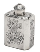 A George I silver tea caddy, with chamfered angles, later repoussé decorated with C scrolls, flowerheads and...