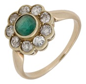 An emerald and diamond cluster ring, the mixed-cut emerald collet-set within a surround of old brilliant-cut...