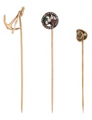 Three stickpins, comprising an antique ruby, emerald and diamond stick pin, mounted in silver and gold, with...