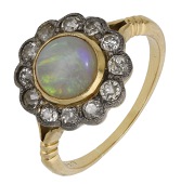 An opal and diamond cluster ring, the opal cabochon within a surround of old brilliant-cut diamonds, between...