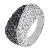 A diamond dress ring, the crossover panels pavé-set with brilliant-cut diamonds and similarly-cut treatment black...
