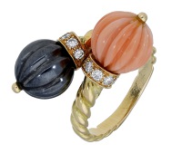 An 18ct gold hematite and coral ring by Chaumet, of crossover design, each terminals set with a reeded coral or...