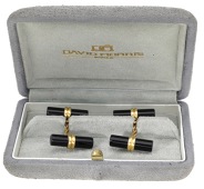 A pair of black hardstone cufflinks retailed by David Morris, circa 1990, the cylindrical batons with ropetwist...