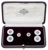 A gentleman’s dress set, comprising a pair of cufflinks and pair of  studs, the circular panels centred with...