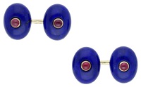 A pair of lapis lazuli and ruby cufflinks, the oval lapis lazuli cabochons each centred with a ruby cabochon, with...