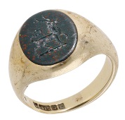A bloodstone intaglio signet ring, carved to depict the crest for Carew, a heraldic antelope trippant, mounted in...
