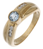 An aquamarine and diamond ring, of crossover design, set with a circular-cut aquamarine with brilliant-cut diamonds...