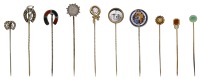 A collection of antique stick pins, including enamelled and gem-set examples, depicting dogs, hunting themes, etc.,...