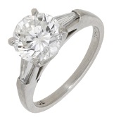 A diamond ring, the brilliant-cut diamond weighing 2.20 carats, in a raised four claw setting between tapered...