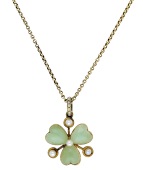 A clover leaf pendant, circa 1900, the carved stained green chalcedony leaves spaced by half-pearls, to a...