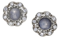 A pair of star sapphire ear studs, the circular star sapphire cabochons within pierced surrounds set with...