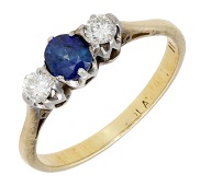 A sapphire and diamond three stone ring, the oval mixed-cut sapphire claw-set between brilliant-cut diamonds, gold...
