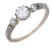 A diamond ring, circa 1900, set with an old brilliant-cut diamond with a similarly-cut diamond to either side and...