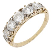 A late 19th century five stone diamond ring, the graduated row of old brilliant-cut diamonds to a pierced scrollwork...