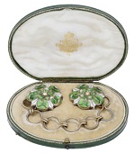 A 19th century enamel cloak clasp, formed of two green and white enamel Tudor roses, with chain connector between,...