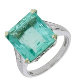 A Colombian emerald and diamond ring, the step-cut emerald, weighing 7.21 carats, between tapered baguette-cut...