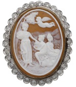 A shell cameo and diamond brooch / pendant, depicting three maidens beneath a putto, within a frame of brilliant-cut...
