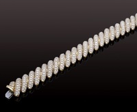 A diamond bracelet retailed by Moussaeiff, composed of diagonal bombé panels, each pavé-set throughout with...