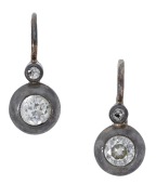 A pair of 19th century earrings, each collet-set with an old brilliant-cut diamond beneath a similarly-cut diamond,...