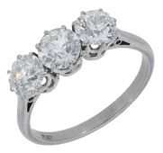 A diamond three stone ring, claw-set with old brilliant-cut diamonds, stamped ‘PLAT’, total diamond weight...
