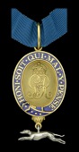 King’s Messenger Badge, G.V.R., silver-gilt and enamel with pendant silver greyhound, ‘No 16’ engraved on...