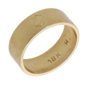 A dress ring, the polished band with screwhead motifs, stamped ‘18K’, ring size I. 	 £150-£200