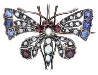 A late 19th century gem-set butterfly brooch, the rose-cut diamond wings with oval-cut sapphire, ruby and garnet...