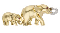 A novelty elephant brooch, the mother elephant with raised diamond-set trunk, the calf following behind, both with...