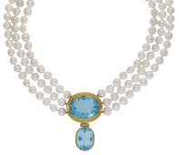A cultured pearl necklace by De Vroomen, 2001, the three strands of cultured pearls with an oval-cut blue paste to...
