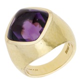 An 18ct gold amethyst ring by De Vroomen, 2010, the amethyst sugarloaf cabochon to a tapered band with hammered...