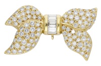An 18ct gold and diamond bow brooch, stylistically modelled and set throughout with brilliant and baguette-cut...