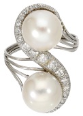 A cultured pearl and diamond ring, set with two cultured pearls with a scroll of single-cut diamonds between, to a...