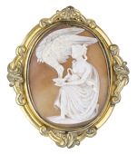 A 19th century shell cameo brooch, carved to depict ‘Hebe and the Eagle’, the goddess kneeling, presenting a cup...