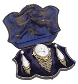 A 19th century shell cameo brooch and earring suite, circa 1865, the oval brooch relief carved to depict a classical...