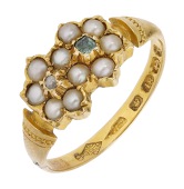 A Victorian seed pearl, emerald and diamond ring, 1872, the bezel of two overlapping flowerheads of half seed pearl...