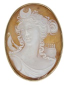 A shell cameo brooch, carved to depict Diana, Goddess of Hunting, in a plain polished frame, Italian assay mark,...