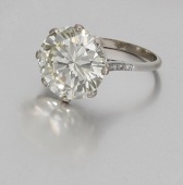 A diamond single stone ring, set with a brilliant-cut diamond, weighing 9.23 carats, in a pierced gallery set with...