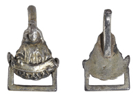 A 16th century dress fastener, the triangular outline depicting the bust of a cherub holding a scroll and with a...
