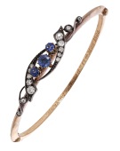 Mafeking interest: A sapphire and diamond hinged bangle, circa 1900, the upper section claw set with three...