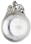 A silver and parcel gilt dish, the handle to the circular bowl pierce-decorated with a sea horse, seaweed, shells...
