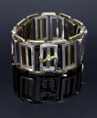 A track-link bracelet by Louis Osman, 1977, the bicolour openwork bracelet of interlocking rectangular links of...