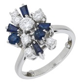 A sapphire and diamond ring, the stylised cluster set with vari-cut sapphires and brilliant-cut diamonds, total...