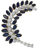 A sapphire and diamond spray brooch, the stylised leaf set with marquise-shaped sapphires and brilliant, baguette,...
