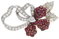 A ruby and diamond spray brooch, the stylised flower set with circular-cut rubies and brilliant-cut diamonds, total...