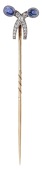 An Art Deco sapphire and diamond stickpin, designed as a bow set with old brilliant-cut diamonds and sugarloaf...